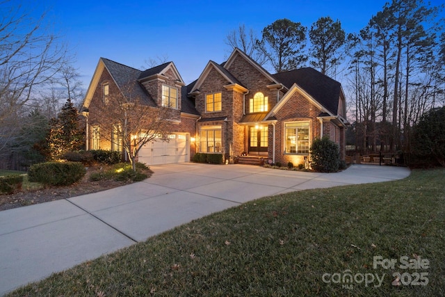 front facade with a garage and a lawn