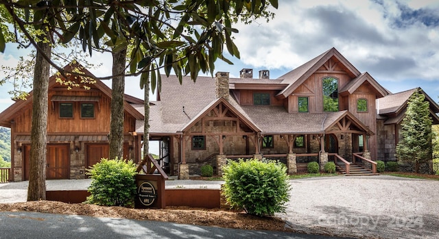 691 Dogwood Ln, Blowing Rock, NC 28605 - view of front of house with a chimney, covered porch, and stone siding