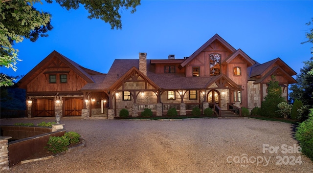 691 Dogwood Ln, Blowing Rock, NC 28605 - view of front of property featuring stone siding, a garage, a porch, a chimney, and driveway