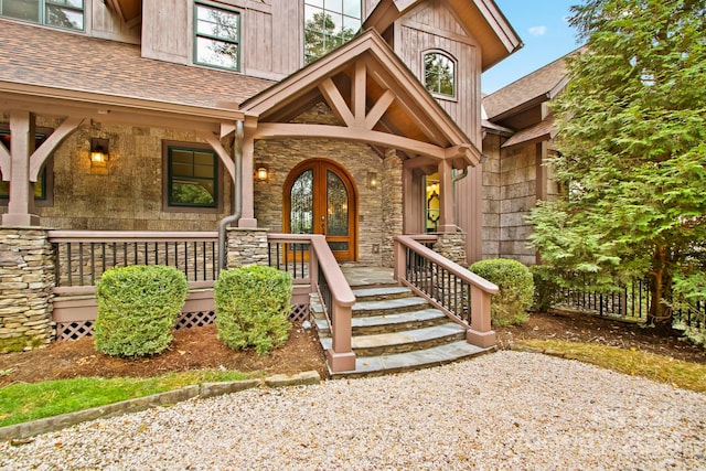 691 Dogwood Ln, Blowing Rock, NC 28605 - entrance to property with covered porch, a shingled roof, and stone siding