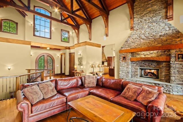 living room featuring plenty of natural light, hardwood / wood-style flooring, high vaulted ceiling, and wooden ceiling