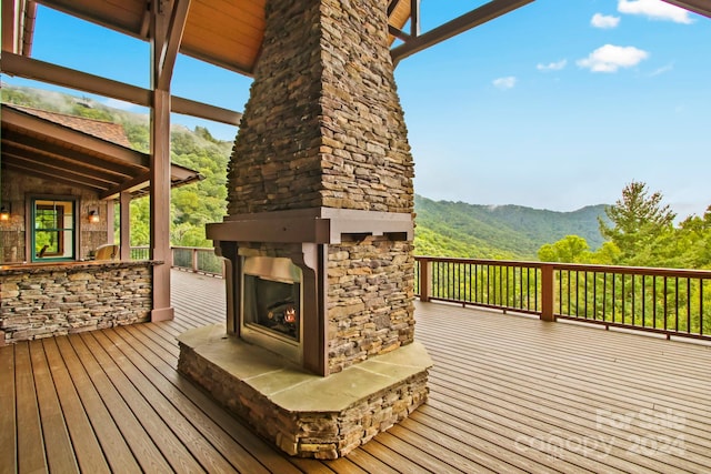 691 Dogwood Ln, Blowing Rock, NC 28605 - wooden terrace featuring a mountain view and an outdoor stone fireplace