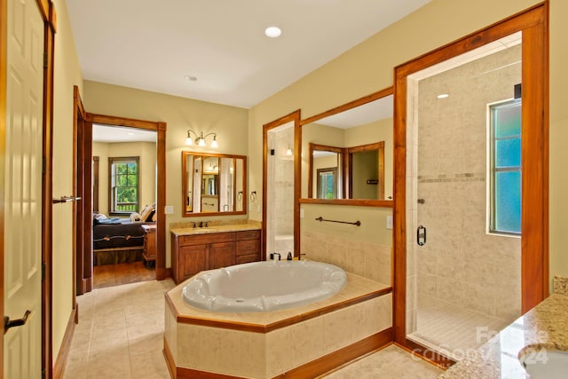 bathroom featuring vanity, independent shower and bath, and tile patterned floors