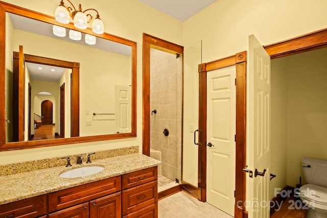 bathroom featuring a tile shower, toilet, tile patterned flooring, and vanity