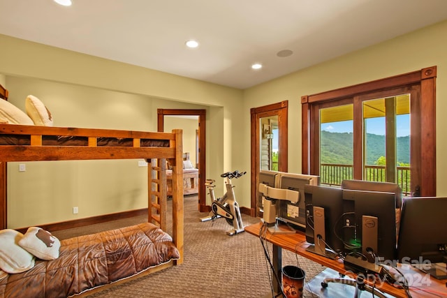 bedroom featuring a mountain view, carpet floors, and access to exterior