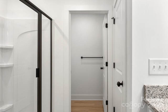 bathroom with vanity, hardwood / wood-style floors, and a shower with shower door