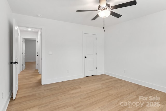 unfurnished room with ceiling fan and light wood-type flooring