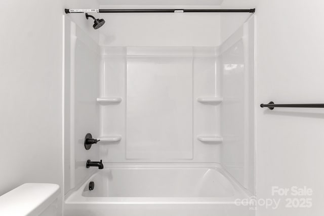 bathroom featuring toilet and shower / bathing tub combination