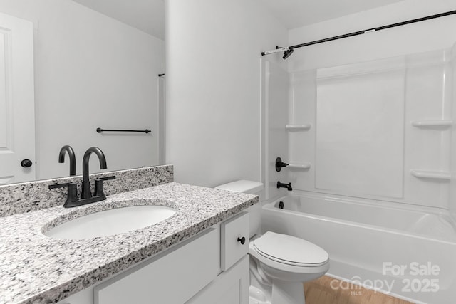 full bathroom featuring vanity, toilet, and  shower combination