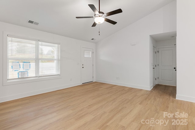 spare room featuring high vaulted ceiling, ceiling fan, and light wood-type flooring