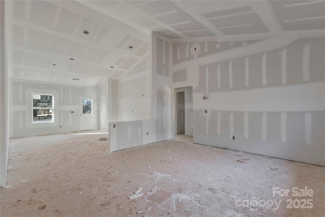 unfurnished living room with vaulted ceiling