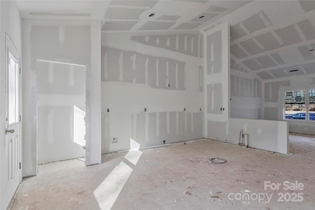 unfurnished living room with vaulted ceiling