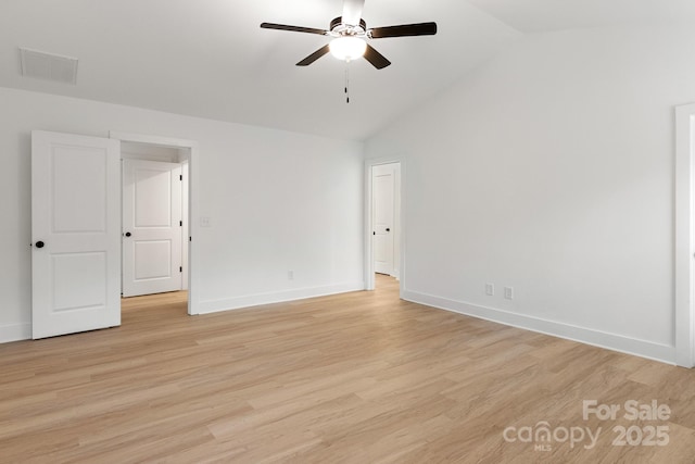 empty room with light hardwood / wood-style flooring, ceiling fan, and vaulted ceiling