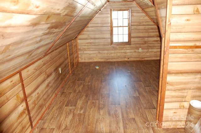 bonus room with wood walls, vaulted ceiling, and hardwood / wood-style flooring