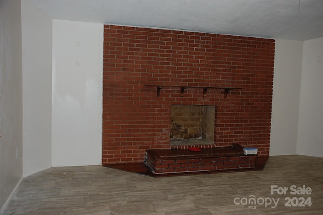 unfurnished living room with a brick fireplace