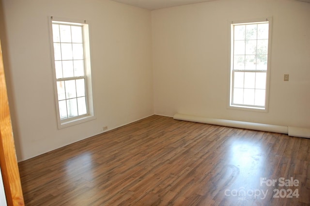 empty room with hardwood / wood-style flooring