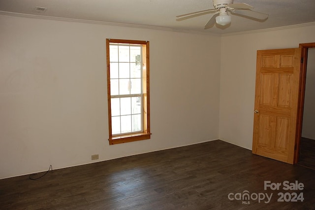 unfurnished room featuring ceiling fan, dark wood-type flooring, a healthy amount of sunlight, and ornamental molding