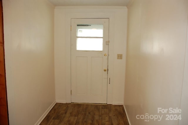 doorway to outside with dark hardwood / wood-style flooring and ornamental molding