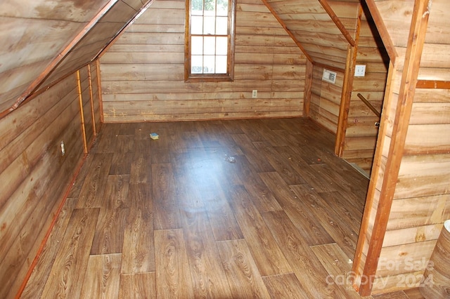 additional living space featuring wood walls, vaulted ceiling, wood-type flooring, and wood ceiling