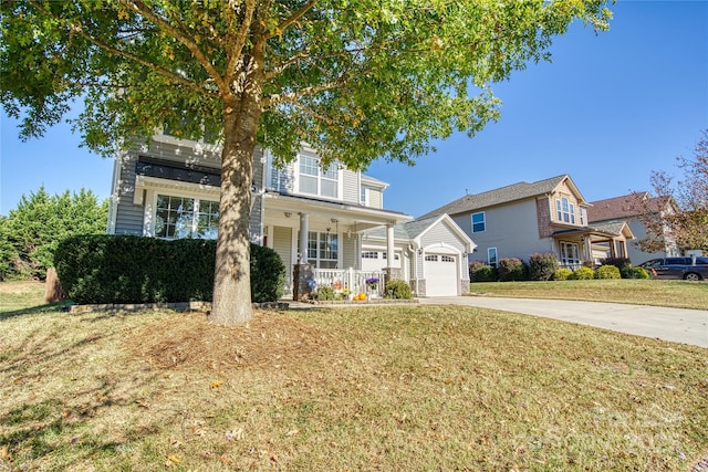 view of front facade with a porch, a garage, and a front lawn