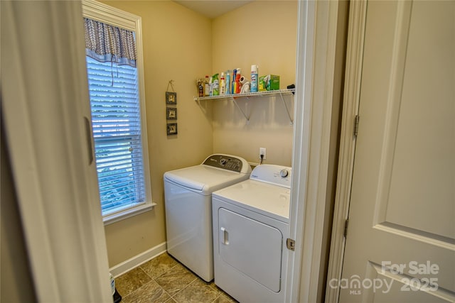 clothes washing area featuring separate washer and dryer