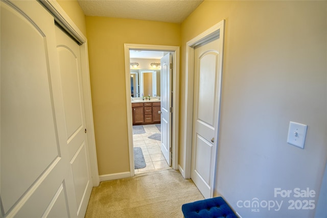 hall featuring light colored carpet