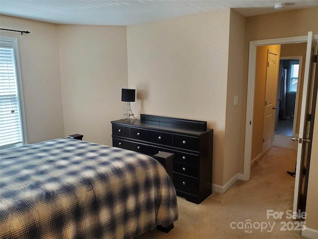 bedroom featuring light colored carpet