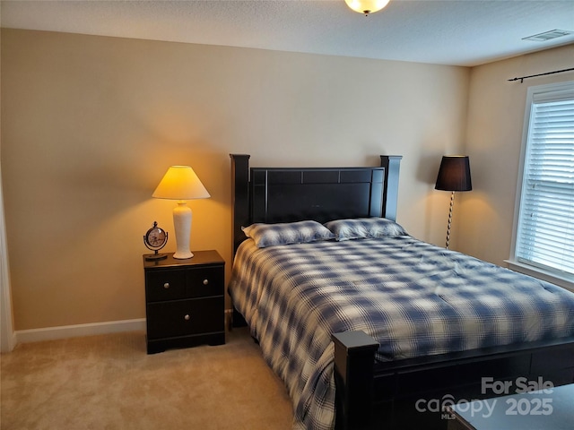 bedroom featuring light carpet