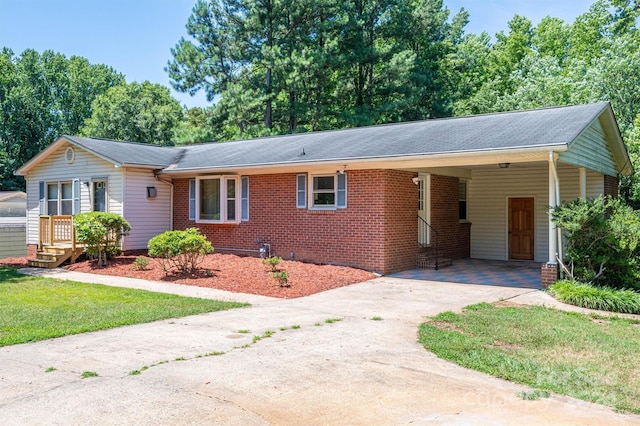 ranch-style house with a carport and a front lawn