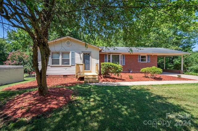 ranch-style house with a carport and a front lawn