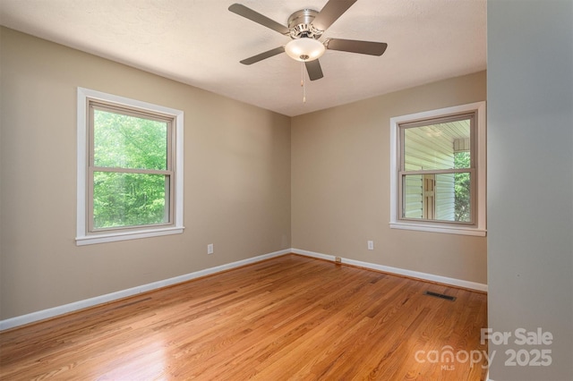 spare room with light hardwood / wood-style flooring and ceiling fan