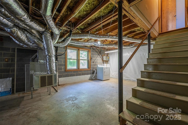 basement featuring separate washer and dryer and heating unit