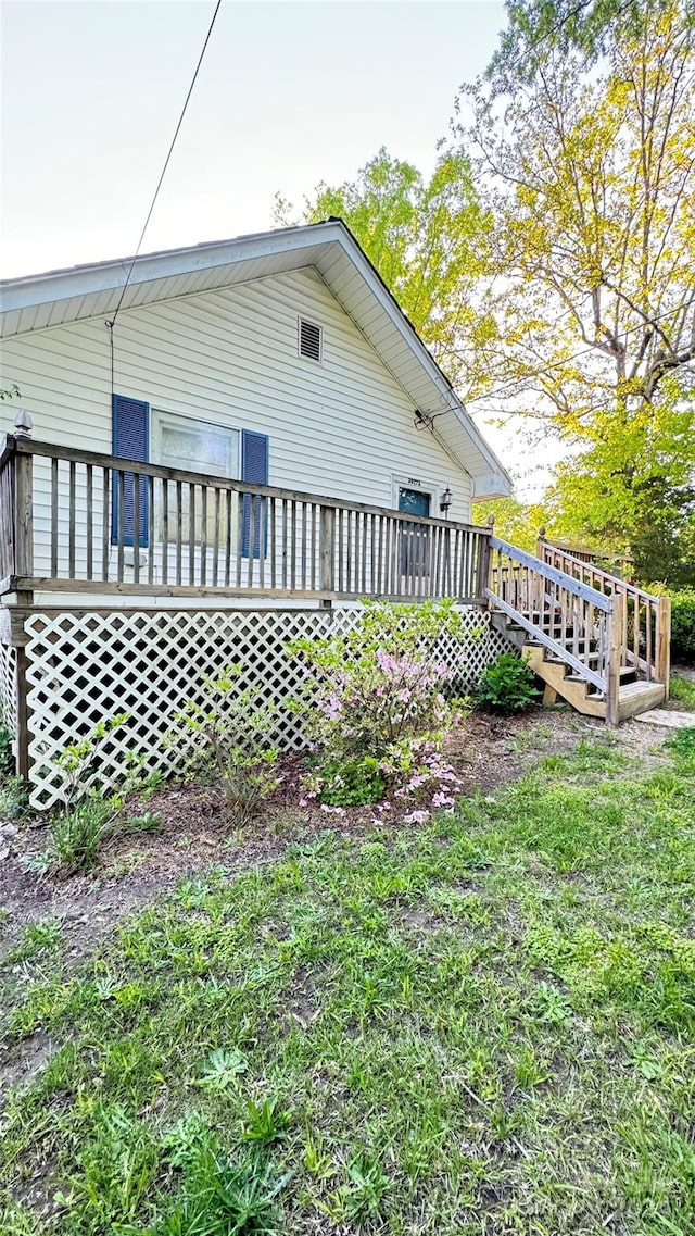 back of house with a deck