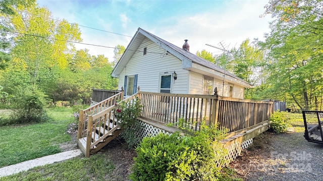 view of side of home featuring a wooden deck