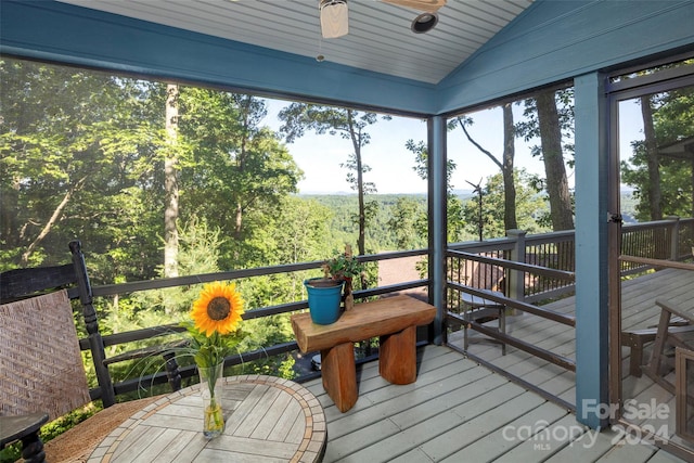 sunroom featuring vaulted ceiling