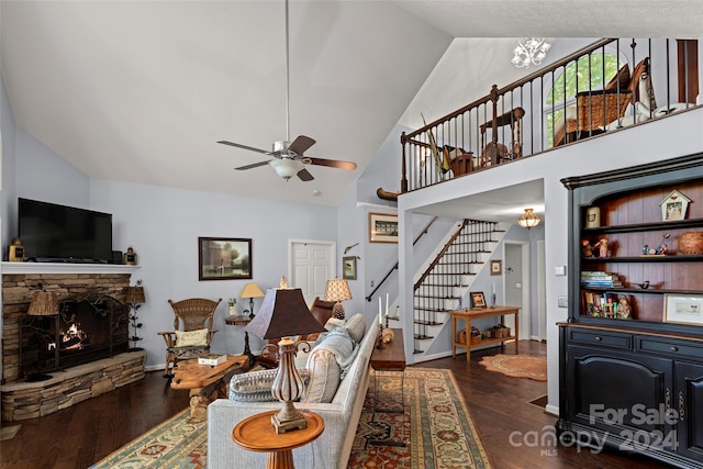 living room with a fireplace, dark hardwood / wood-style floors, high vaulted ceiling, and ceiling fan