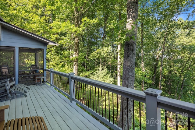 wooden terrace featuring a sunroom