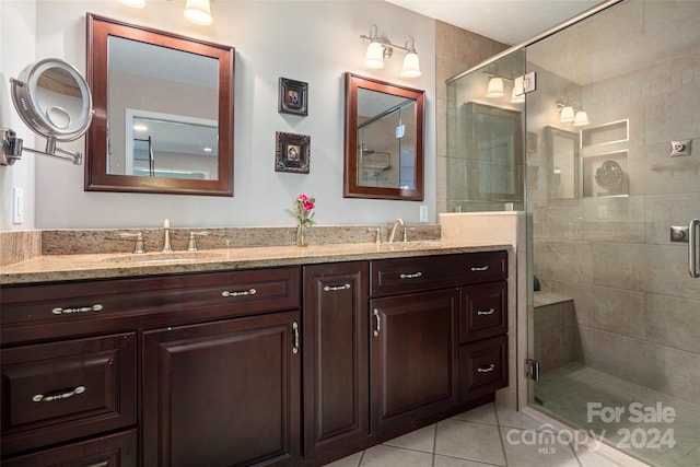 bathroom with tile patterned flooring, vanity, and a shower with shower door