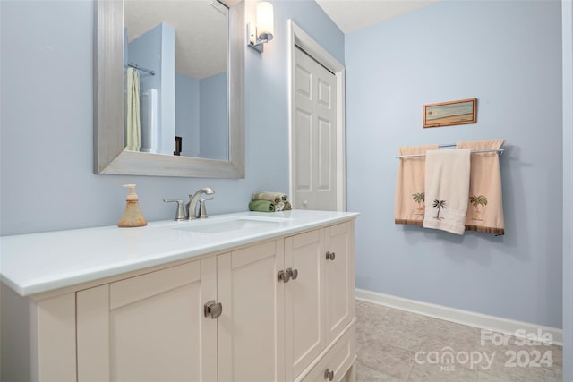 bathroom featuring tile patterned floors and vanity