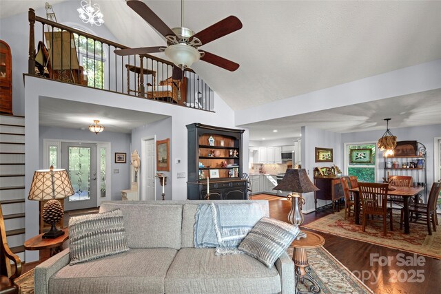 270 Ridge Dr, Saluda, NC 28773 - living area with ceiling fan with notable chandelier, a healthy amount of sunlight, stairway, and wood finished floors