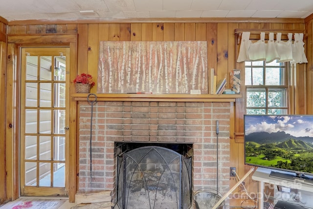 room details with a mountain view, wood walls, and a brick fireplace