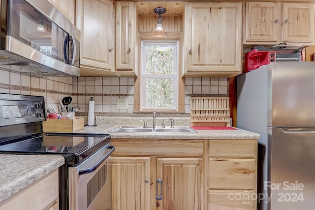 kitchen with backsplash, light brown cabinets, stainless steel appliances, and sink