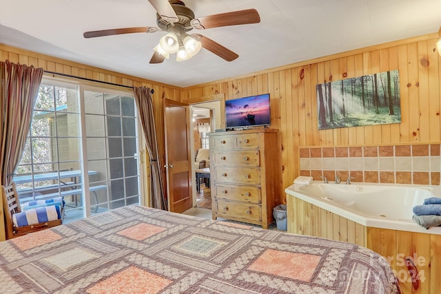 bedroom featuring ceiling fan and wood walls