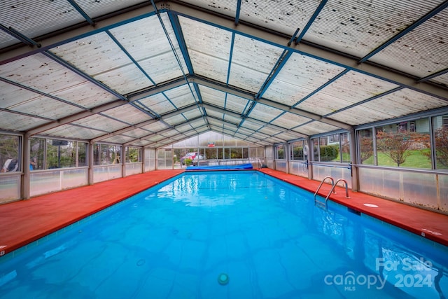 view of swimming pool with glass enclosure