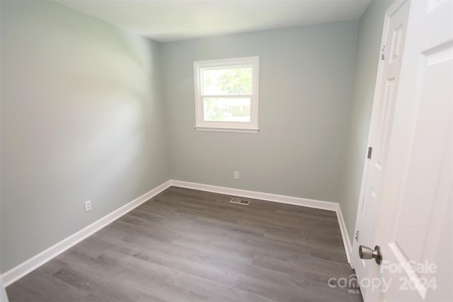 spare room with wood-type flooring