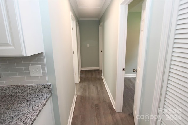 corridor featuring ornamental molding and dark hardwood / wood-style floors