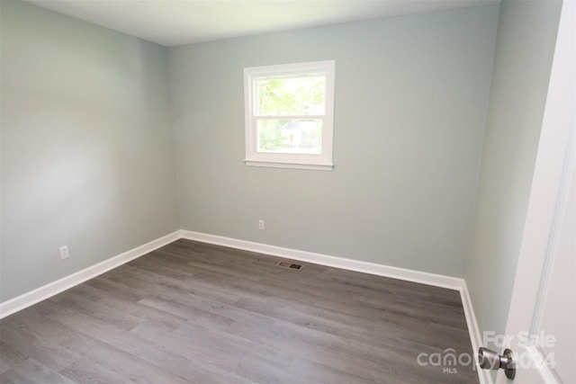 empty room with hardwood / wood-style floors