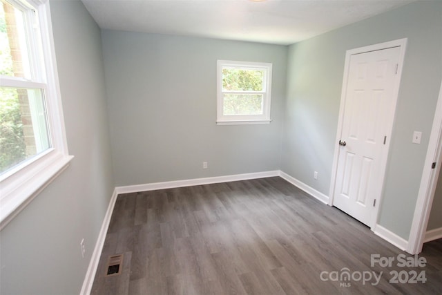 empty room with dark wood-type flooring