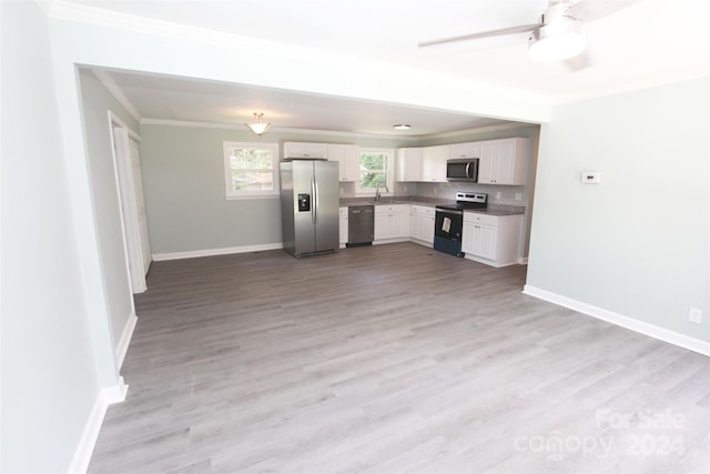 kitchen with white cabinetry, stainless steel appliances, backsplash, light wood-type flooring, and sink