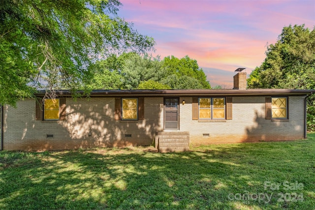 ranch-style house featuring a lawn